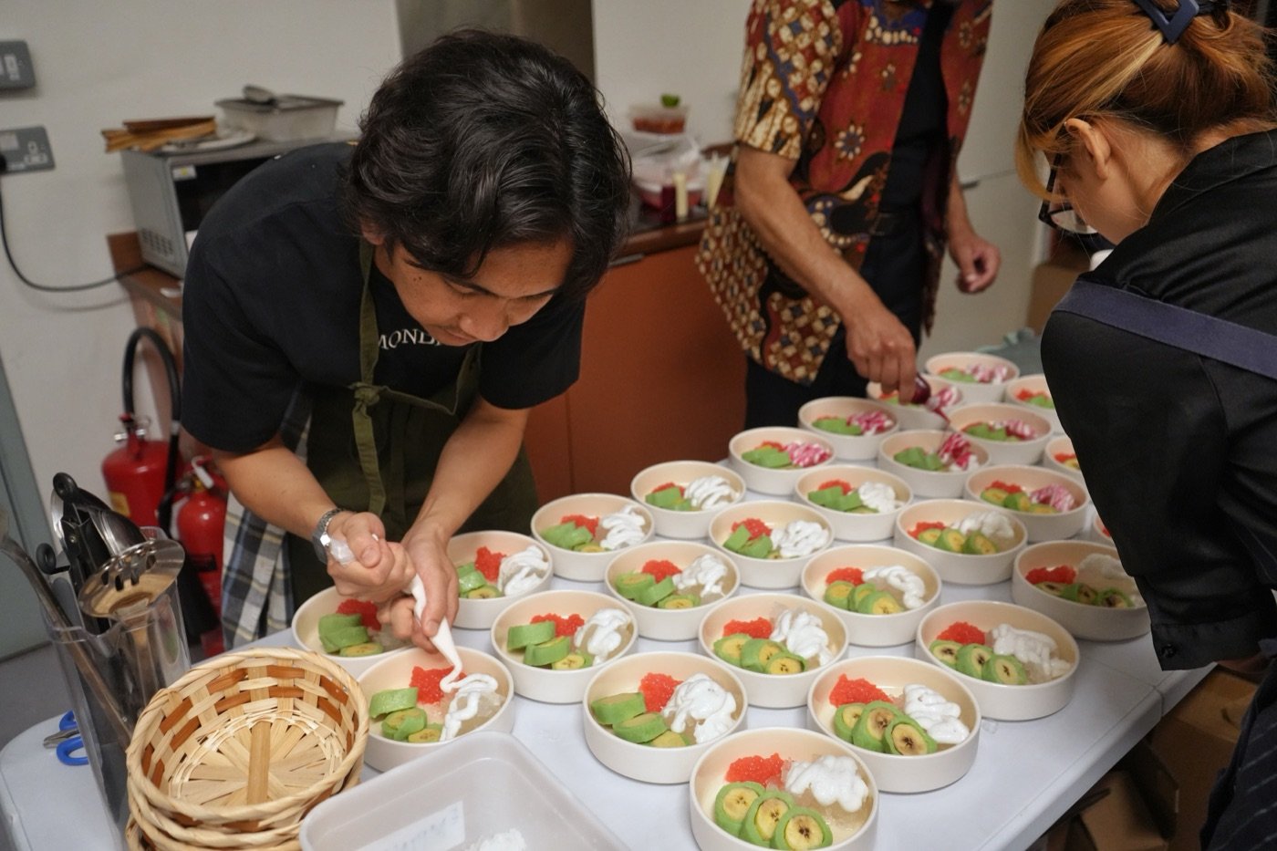 The Jumpa Rasa kitchen plating Es Pisang Ijo desserts for the table